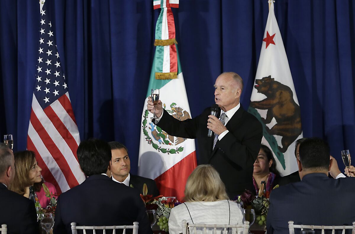 Gov. Jerry Brown makes a toast to Mexican President Enrique Pena Nieto in August. California and Mexico signed an agreement to work together on climate change when the governor was visiting the state's southern neighbor last year.