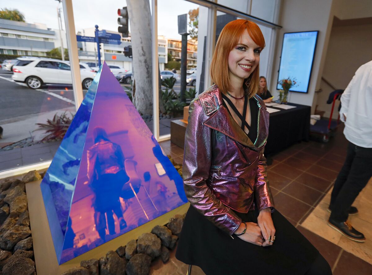 Artist Kelly Berg with her exhibit, "Pyramidion," in the lobby of the Laguna Art Museum during the Art and Nature show.