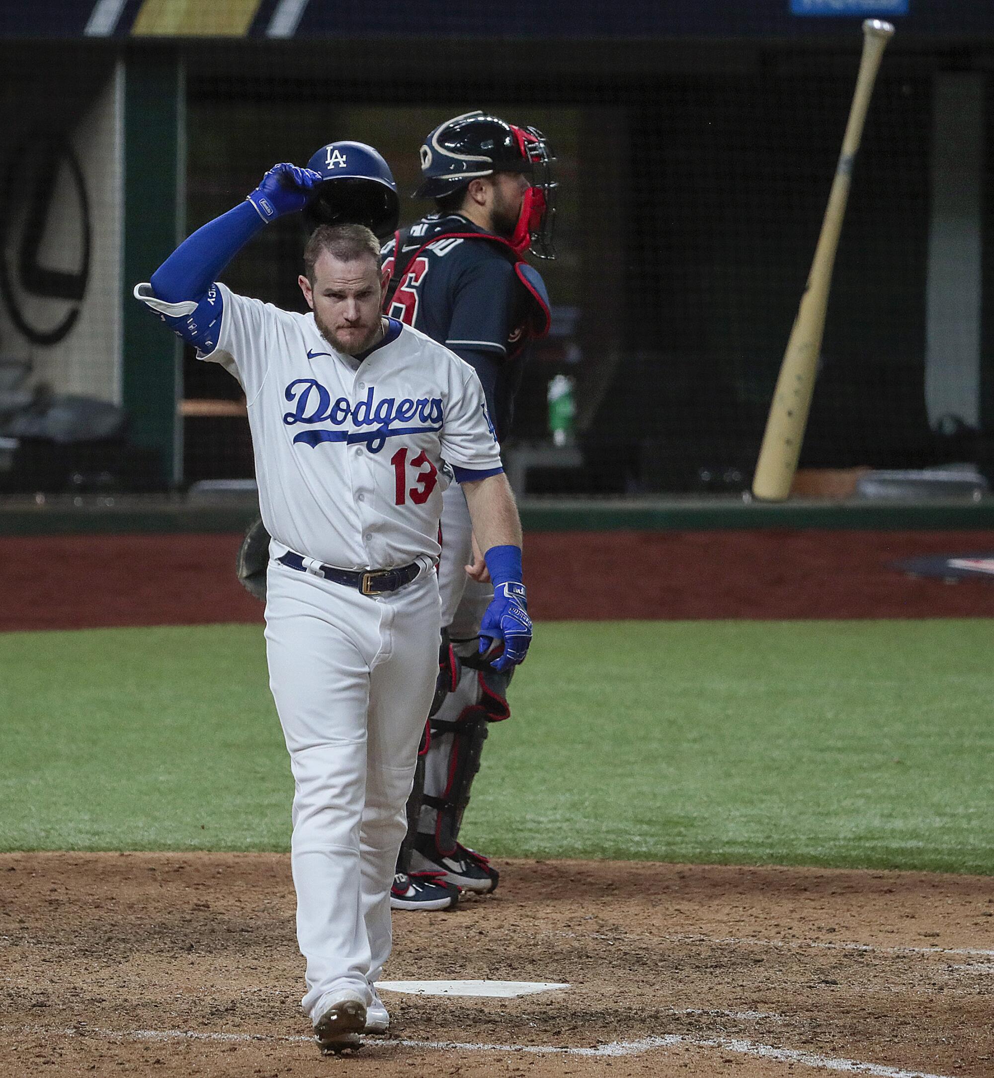 Dodgers first baseman Max Muncy tosses his bat in frustration.