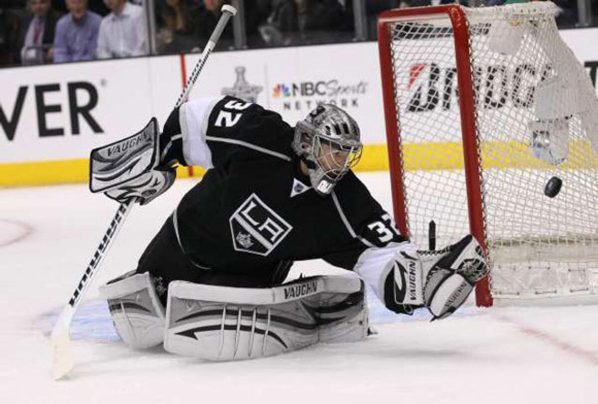 Jonathan Quick of the Kings knocks away a shot by the Vancouver Canucks in Game 3.