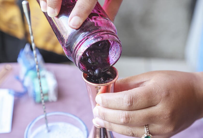 Measure out blueberry syrup to mix into the milk.