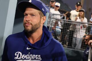 Fans yell for an autograph as Dodgers pitcher Clayton Kershaw enters the dugout.