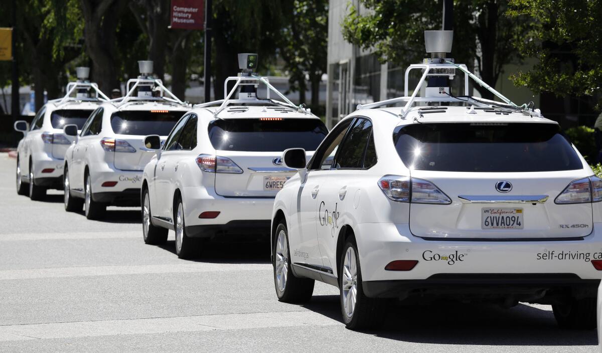 A row of Google self-driving Lexus cars are lined up at a Google event outside the Computer History Museum in Mountain View, Calif., on May 13, 2014.