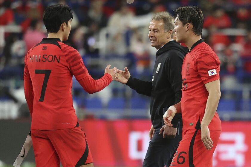 South Korea's head coach Jurgen Klinsmann, second from right, encourages South Korea's Son Heung-min, left, as South Korea's Oh Hyeon-gyu, right, walks after their friendly soccer match between South Korea and Colombia in Ulsan, South Korea, Friday, March 24, 2023. (Shin Hyun-woo/Yonhap via AP)