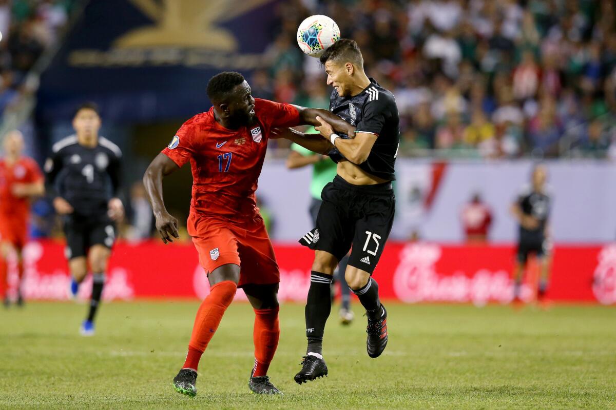 Hector Moreno #15 of the Mexico heads the ball while being defended by Jozy Altidore #17 of the United States in the second half during the 2019 CONCACAF Gold Cup Final at Soldier Field on July 07, 2019 in Chicago, Illinois.