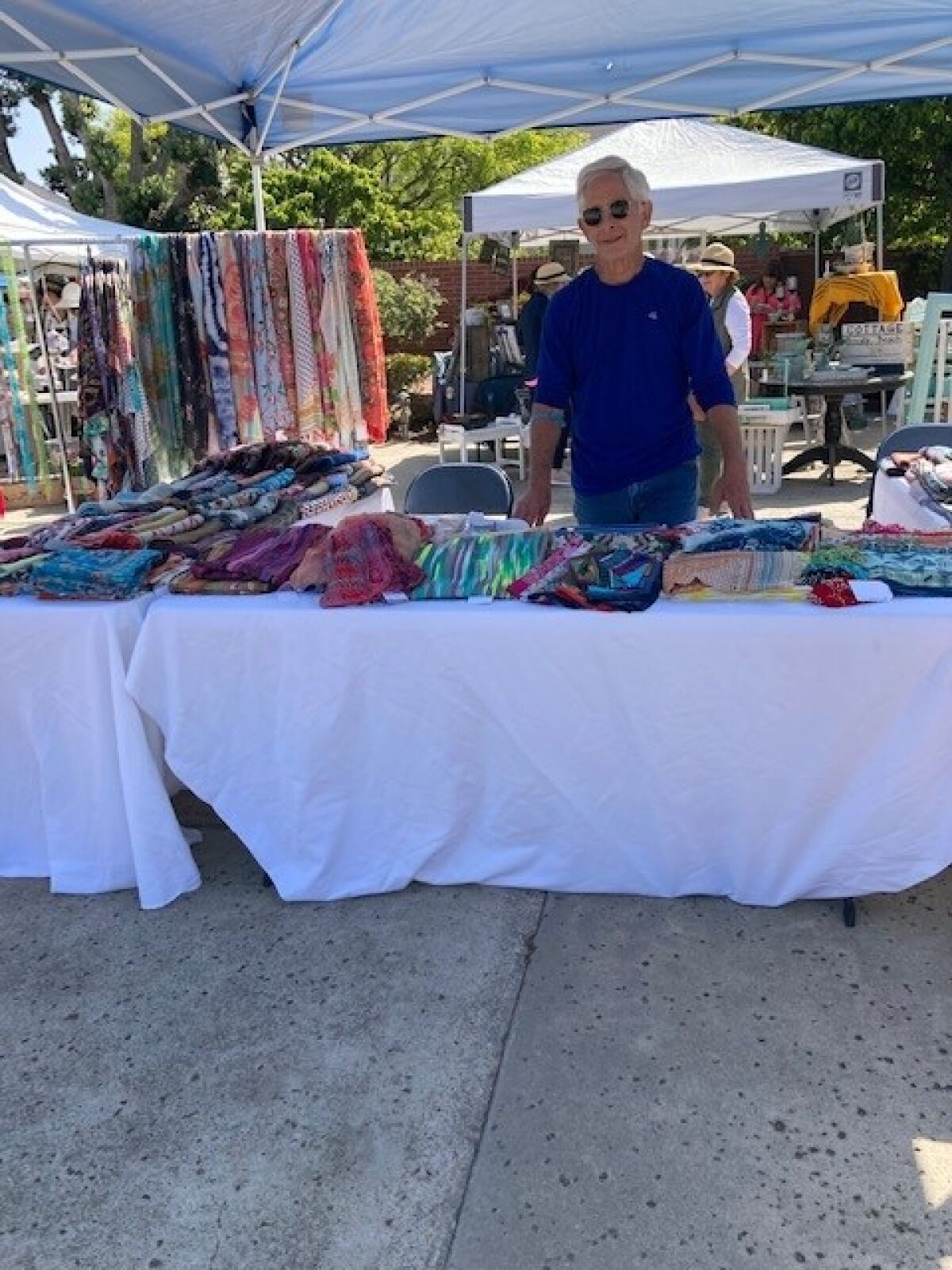 Bruce Belsky of Vicky La Jolla shows the types of items that he and his wife, Valerie, bring to the Christmas Marketplace.
