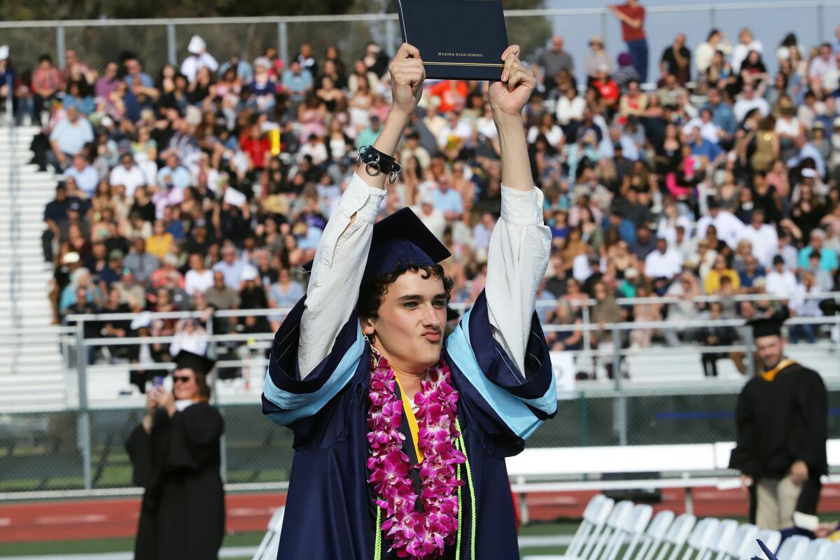 Tray Wallace holds up his diploma during Marina High School's 2023 commencement ceremony.