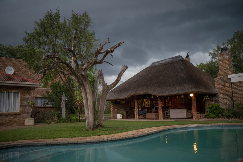 Storm clouds move over the Tamboti Bush Lodge in the Dinokeng game reserve near Hammanskraal, South Africa Saturday Dec. 4, 2021. Recent travel bans imposed on South Africa and neighboring countries as a result of the discovery of the omicron variant in southern Africa have hammered the country’s safari business, already hard hit by the pandemic. (AP Photo/Jerome Delay)