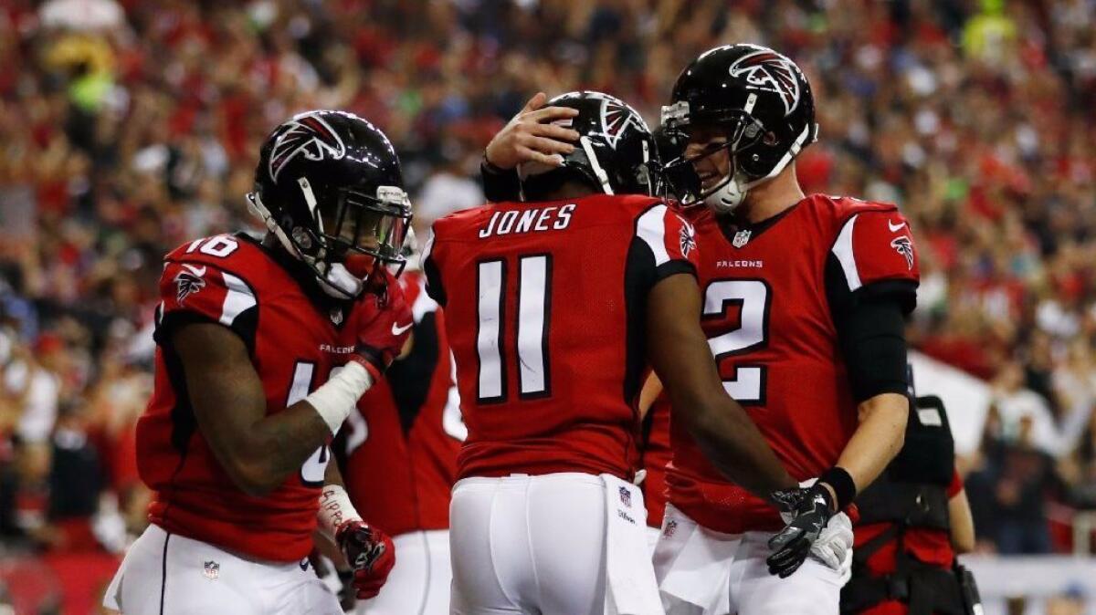 Falcons quarterback Matt Ryan celebrates with receiver Julio Jones after a touchdown against the Seahawks on Saturday.