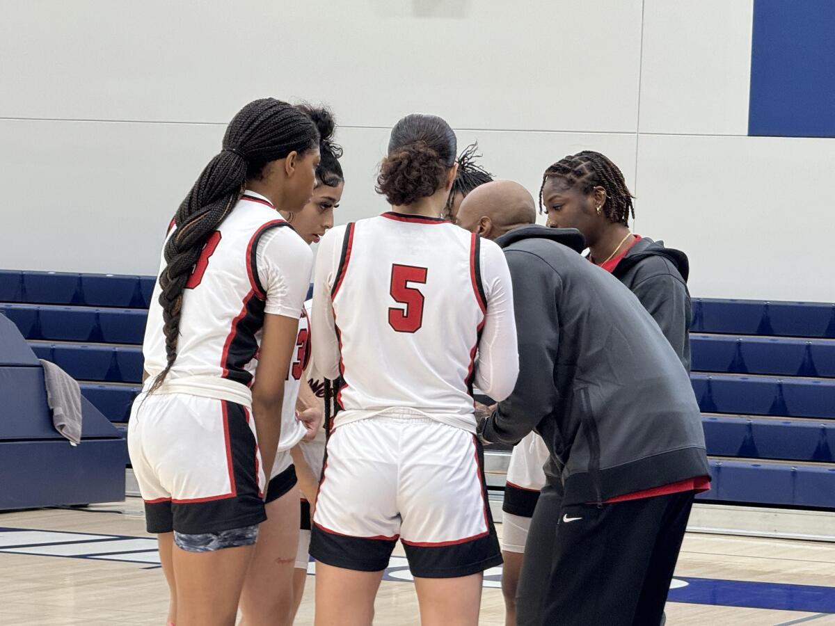 Westchester girls' basketball players listen to their coaches.