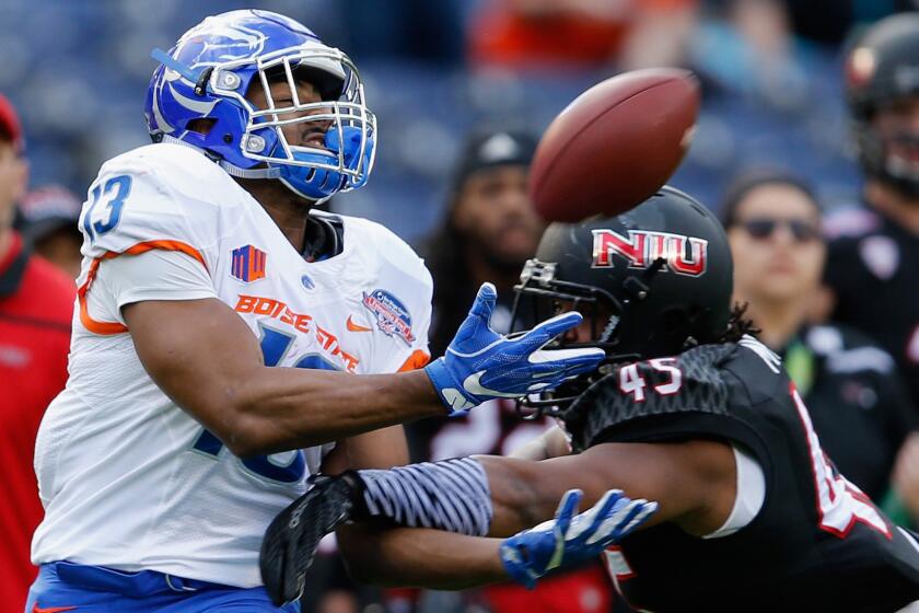 Boise State running back Jeremy McNichols makes a catch despite tight coverage by Northern Illinois linebacker Boomer Mays on Wednesday.