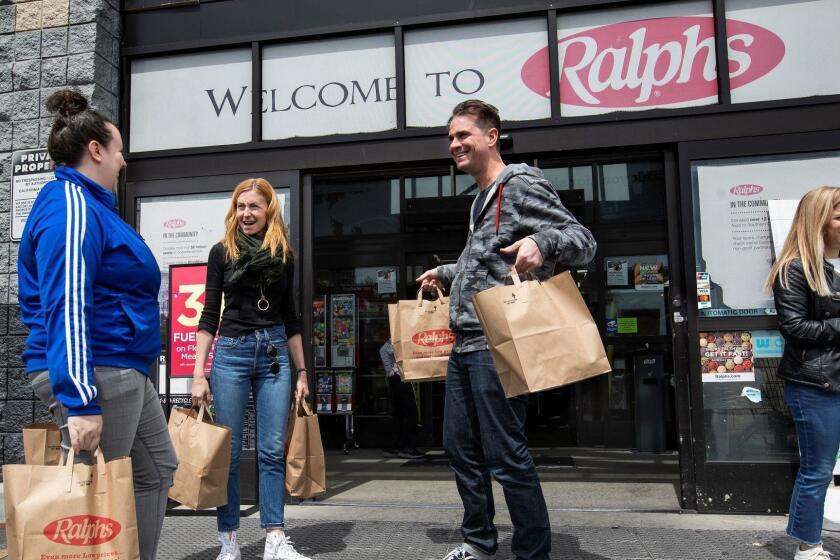 LOS ANGELES, CA-APRIL 5, 2019: left to right-Anna McGorman, Director of Culinary Operations for Milk Bar, Christina Tosi, Milk Bar Head Chef, and Scotty Blenkarn, Milk Bar Lab Supervisor, make their way with bags full of ingredients for research and development of a compost cookie flavored treat, after shopping at Ralphs Supermarket on La Brea Ave in Los Angeles. (Mel Melcon/Los Angeles Times)