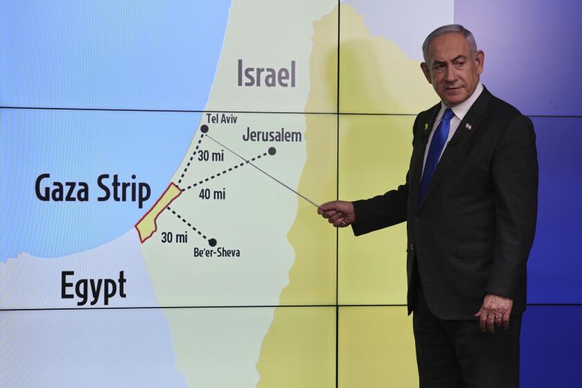 Israeli Prime Minister Benjamin Netanyahu gestures in front of a map during a press conference at the Government Press office in Jerusalem, Wednesday, Sept. 4, 2024. (Abir Sultan/Pool via AP)