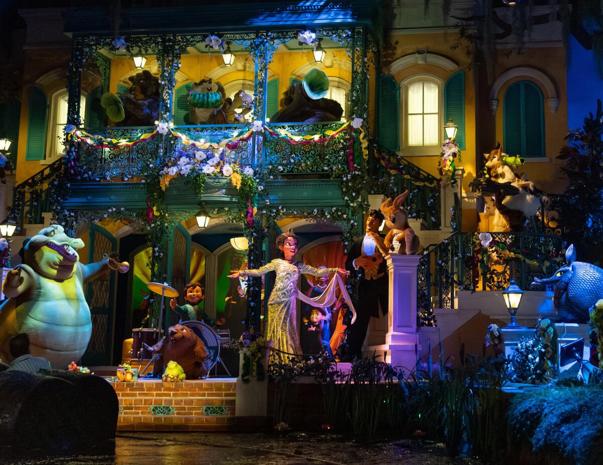 A princess, an alligator and other characters appear before a mansion at a bayou.