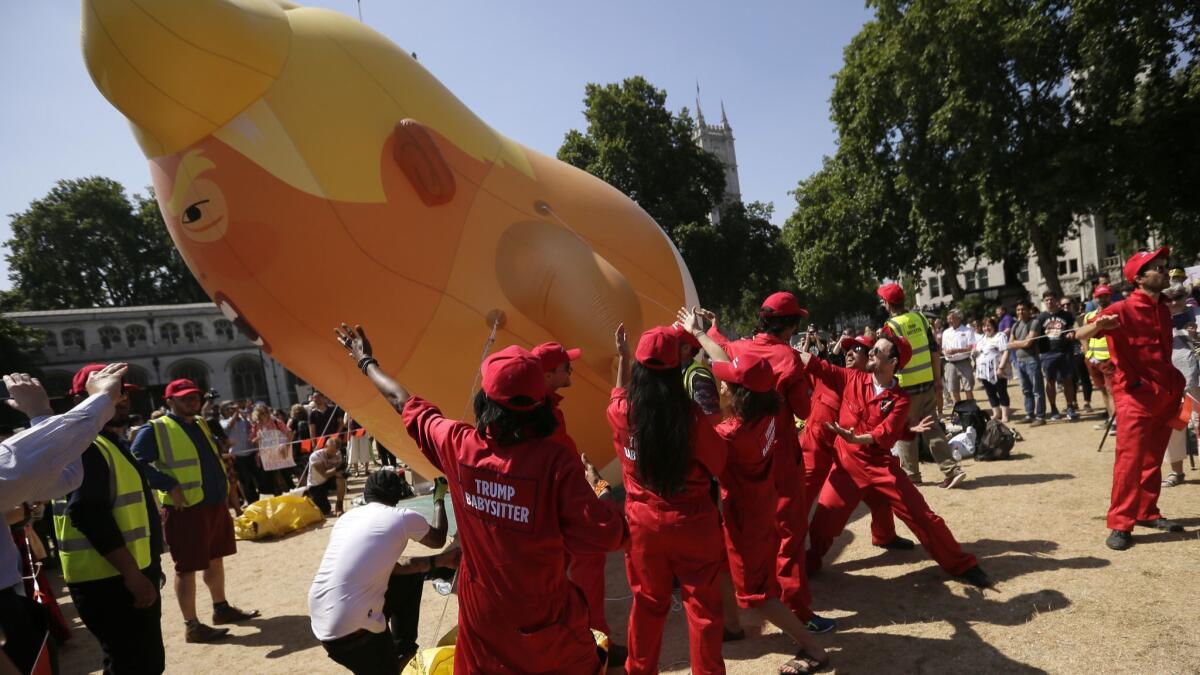 A blimp is brought back down to the ground Friday in Parliament Square in London after it was flown as a protest against U.S. President Trump's visit to the U.K.