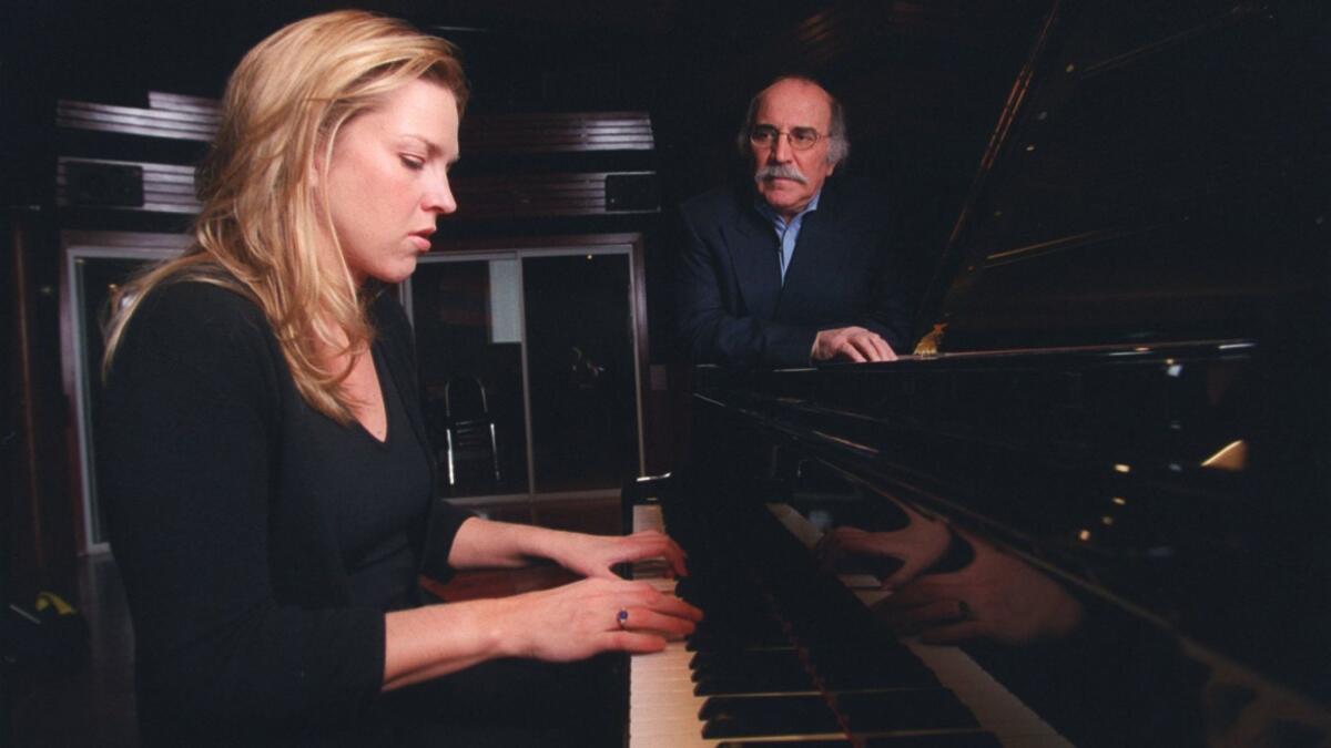 Tommy LiPuma looks on as recording artist Diana Krall works on a new album.