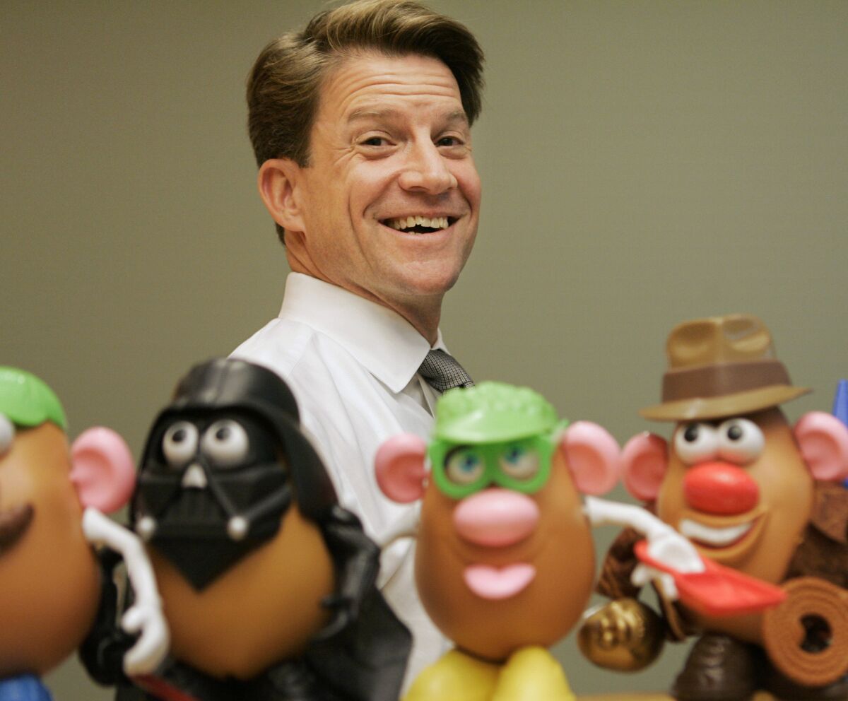 FILE - In this Tuesday, May 20, 2008, file photo, Brian Goldner, of Hasbro, stands next to some of the company's toy figures at Hasbro's headquarters, in Pawtucket, R.I. Toy and entertainment company Hasbro has announced that its CEO and chairman Brian D. Goldner has died at age 58. The announcement Tuesday, Oct. 12, 2021, comes two days after the company said Goldner was taking a medical leave of absence from his CEO role, effective immediately. (AP Photo/Steven Senne, File)