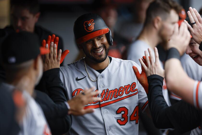 Baltimore Orioles' Aaron Hicks celebrates in the dugout after scoring on a single by Cedric Mullins off Cleveland Guardians relief pitcher Sam Hentges during the fifth inning of a baseball game, Sunday, Sept. 24, 2023, in Cleveland. (AP Photo/Ron Schwane)