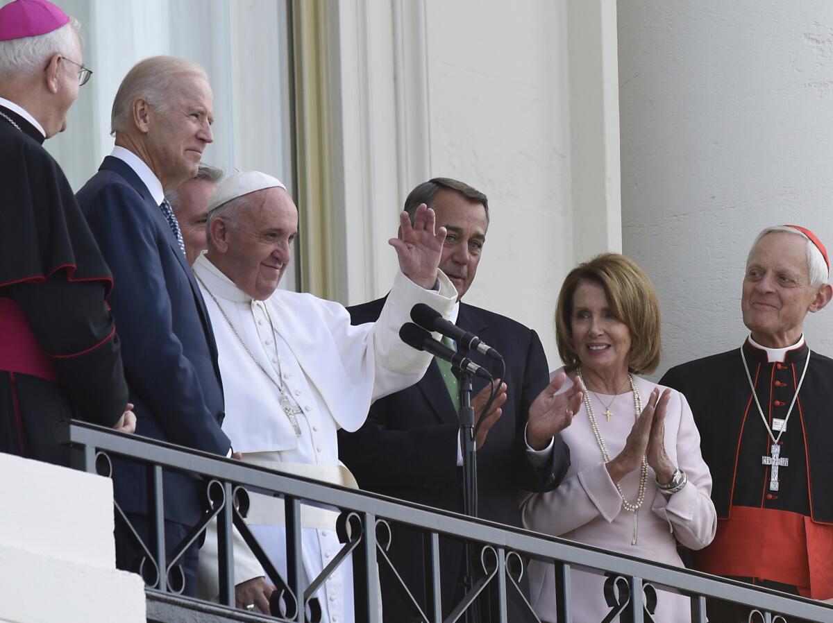 Pope Francis, joined by Vice President Joe Biden, Speaker of the House John Boehner, and Congresswoman Nancy Pelosi, waves to the crowd from a balcony of the U.S. Capital Building in Washington on Sept. 24.