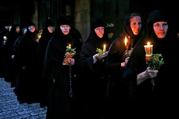 Christian Orthodox nuns walk in a procession paying homage to the Virgin Mary in Jerusalem.