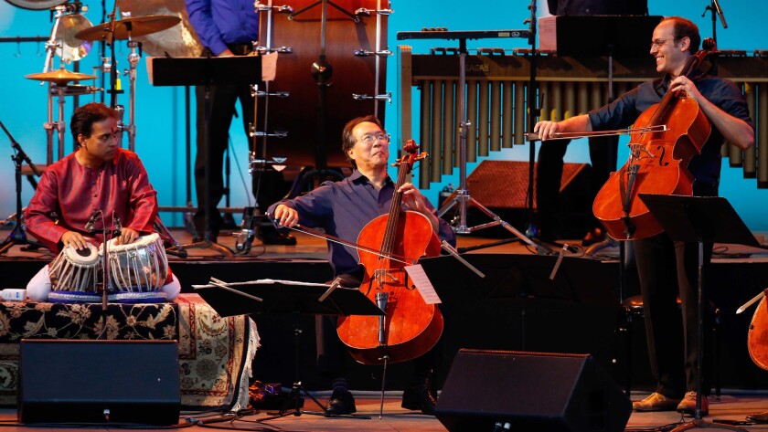 Yo-Yo Ma, flanked by Sandeep Das, left, and Mike Block, perform with other members of the Silk Road Ensemble on Sunday at the Hollywood Bowl.