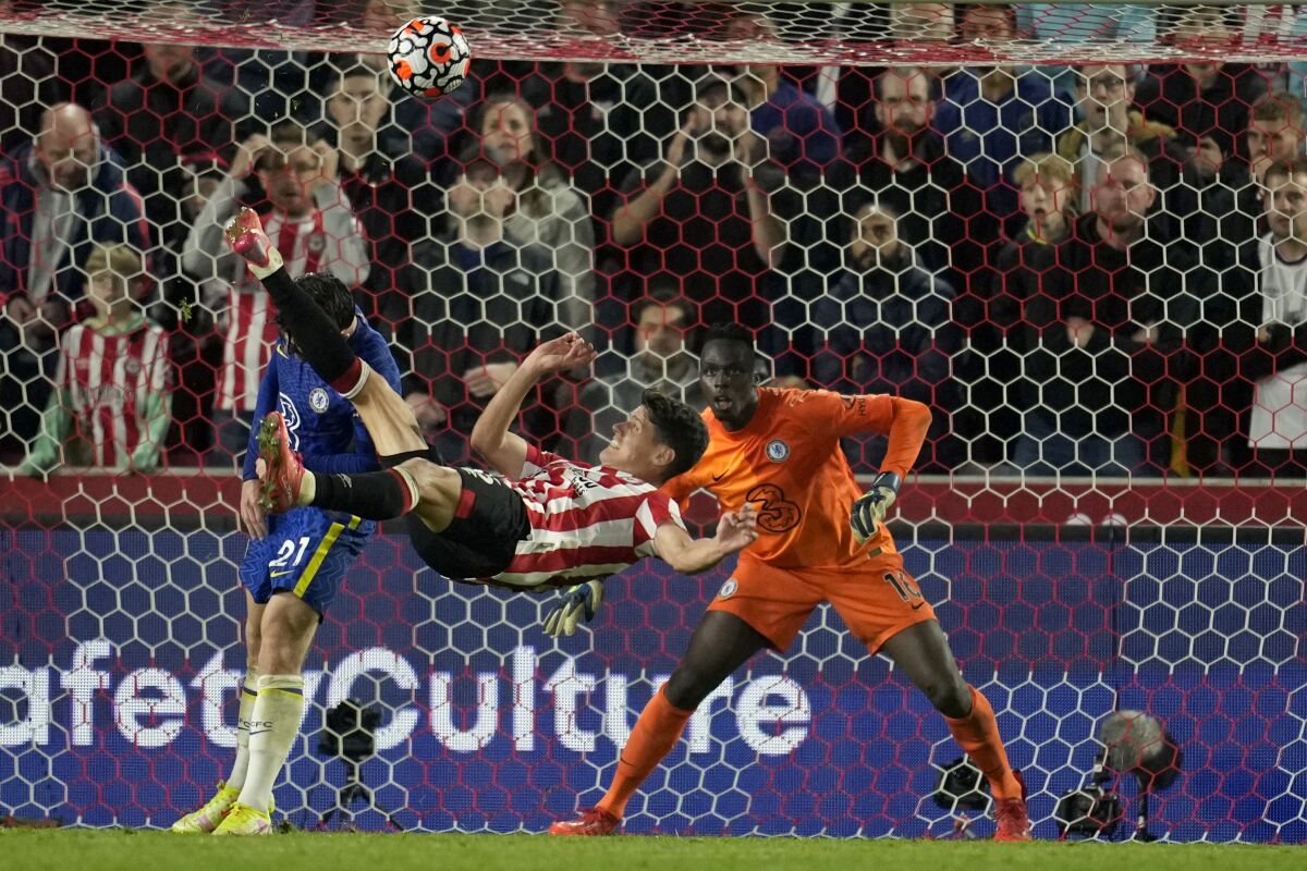 Brentford's Christian Norgaard tries to score with an overhead kick during the English Premier League soccer match between Brentford and Chelsea at Brentford Community Stadium in London, Saturday, Oct. 12, 2021. (AP Photo/Matt Dunham)