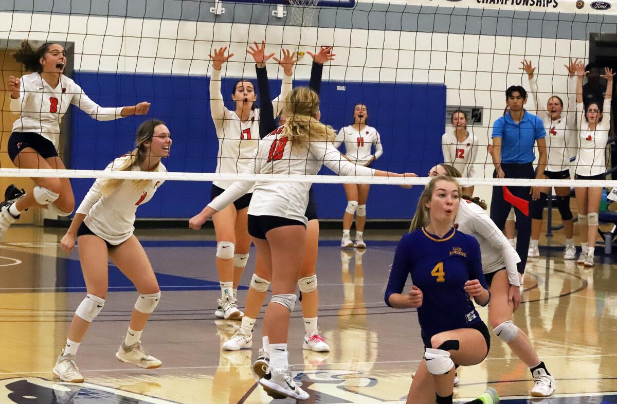 Pacifica Christian girls' varsity volleyball celebrate scoring against Nordhoff in a championship match.