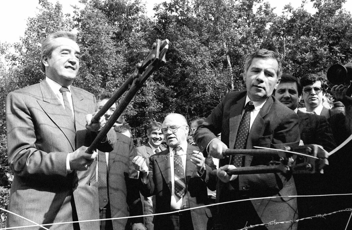 Foreign ministers Gyula Horn, right, representing Hungary, and Alois Mock, representing Austria, in 1989 cut through a barbed-wire fence on the common border of their countries, symbolizing the fall of the Iron Curtain.