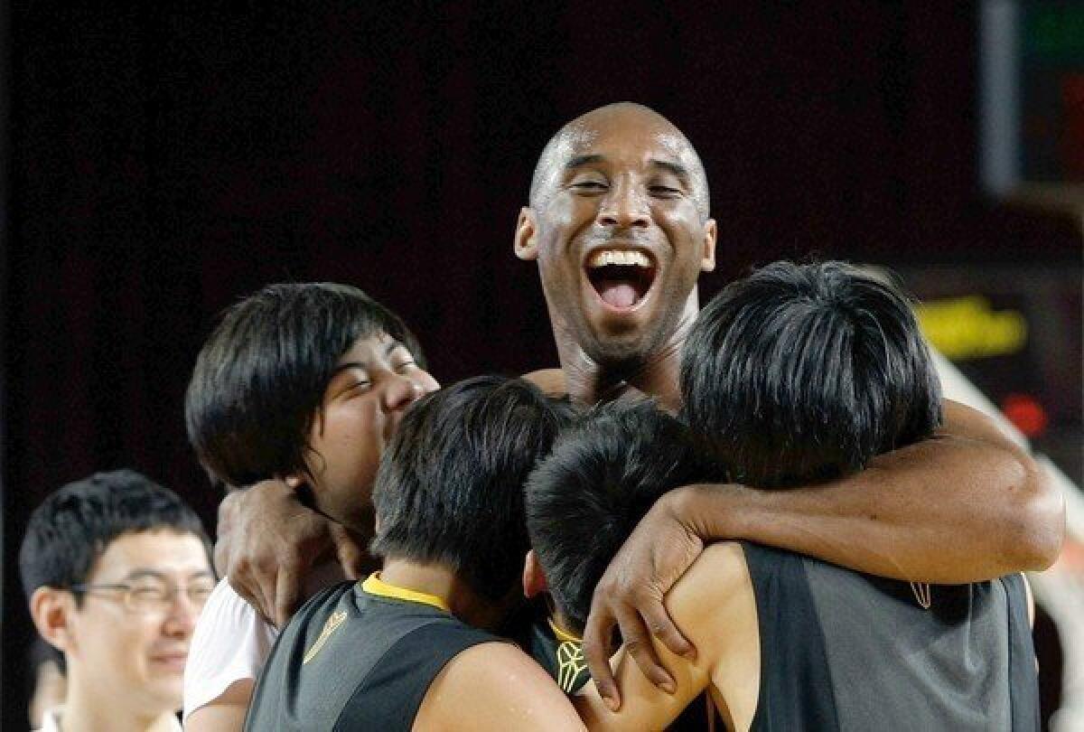 Kobe Bryant hugs South Korean fans during a promotional tour through Asia during the 2011 offseason.