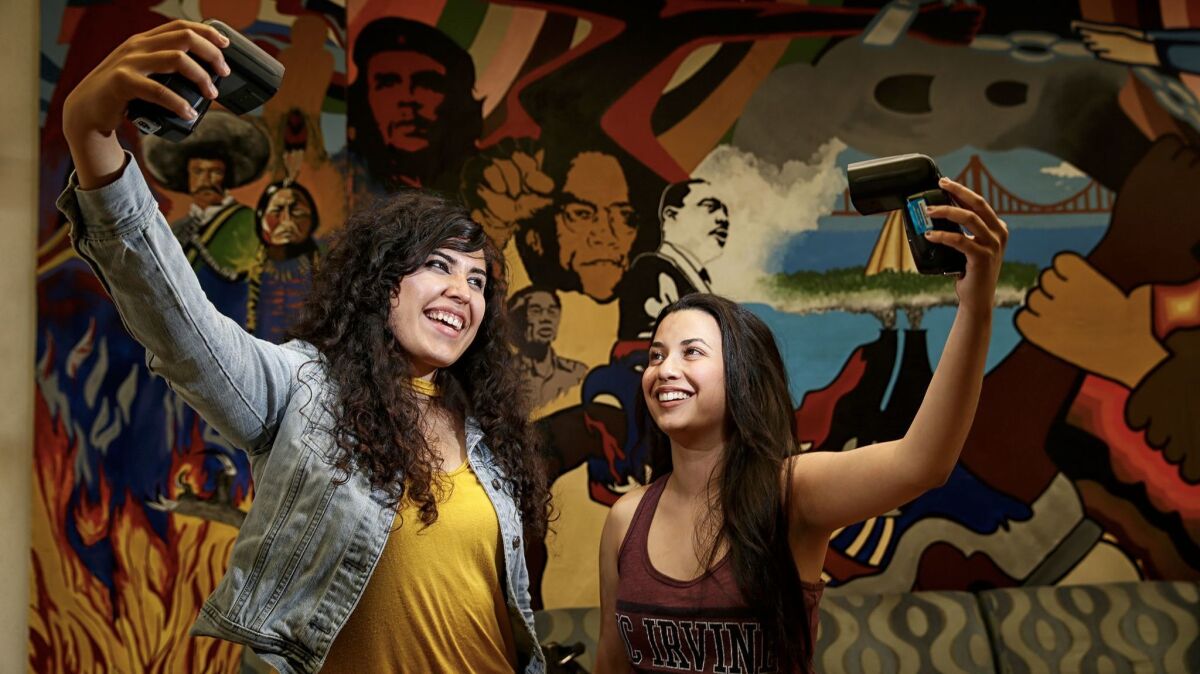 UC Irvine students Angela Vera, left, and Daniela Estrada are part of the growing Latino student population at the university.