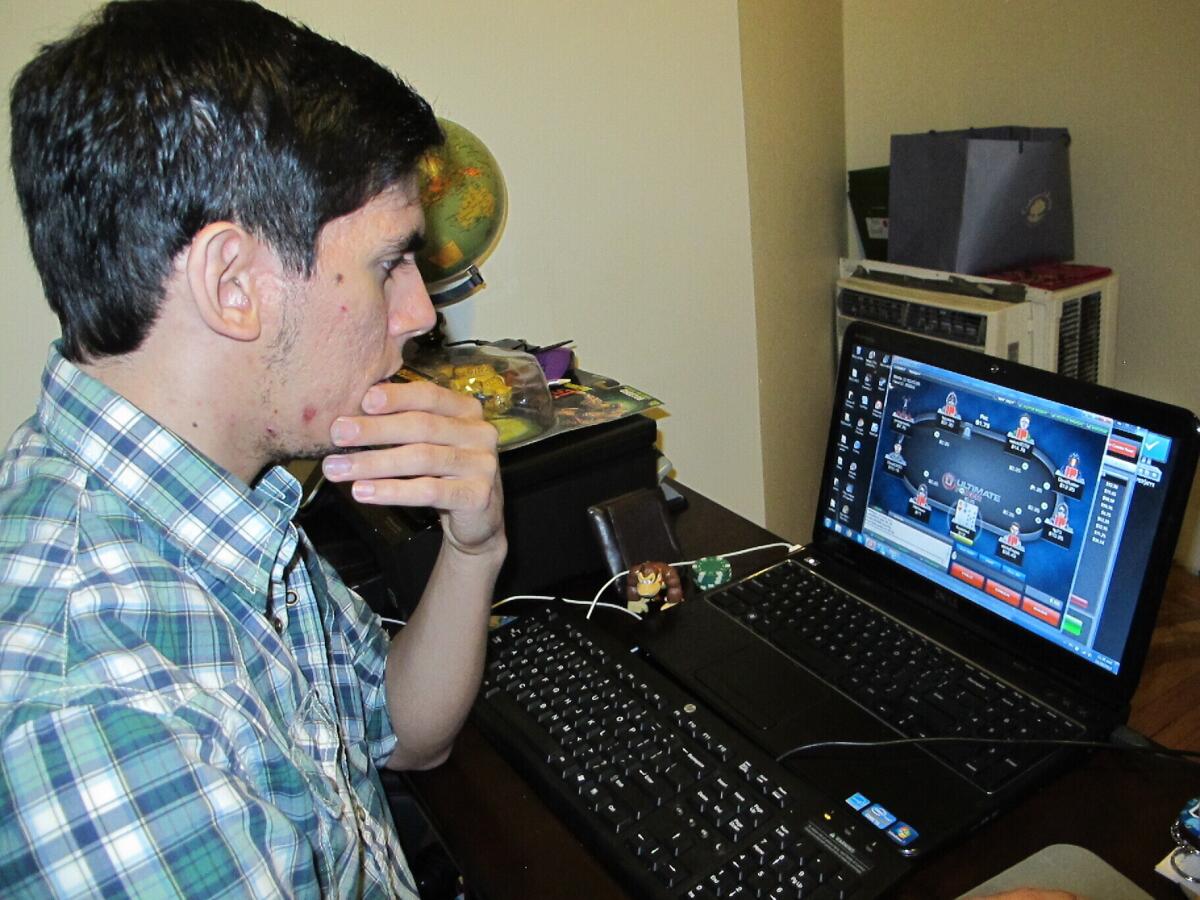 This Nov. 26, 2013 photo shows Jon Hernandez of Roselle Park N.J. playing a game of Internet poker from his home on the day after it became legal in New Jersey. On Thursday, Sept. 15, 2022, New Jersey lawmakers held a hearing to consider extending authorization for the state’s highly successful online gambling industry for another decade, through 2033. (AP Photo/Wayne Parry, file)