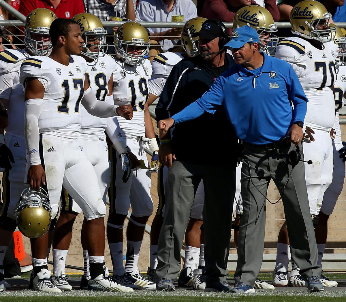UCLA Coach Jim Mora tries to pump up quarterback Brett Hundley in the third quarter of a game against Stanford in October 2013. The Bruins lost that contest, 24-10.