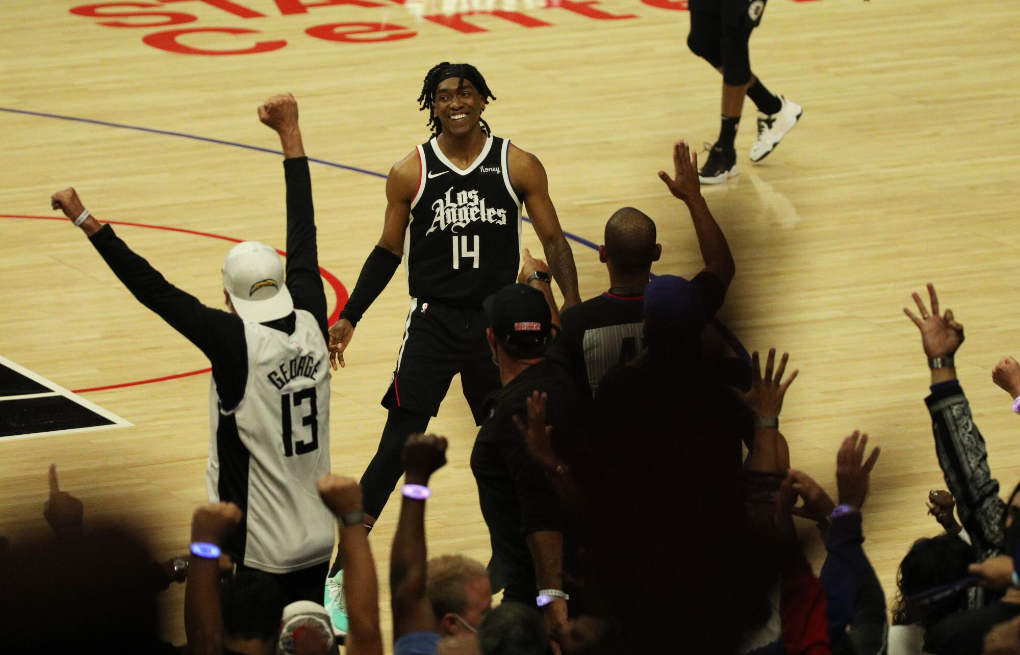 Clippers guard Terance Mann joins fans in celebrating a series-clinching victory over the Jazz.