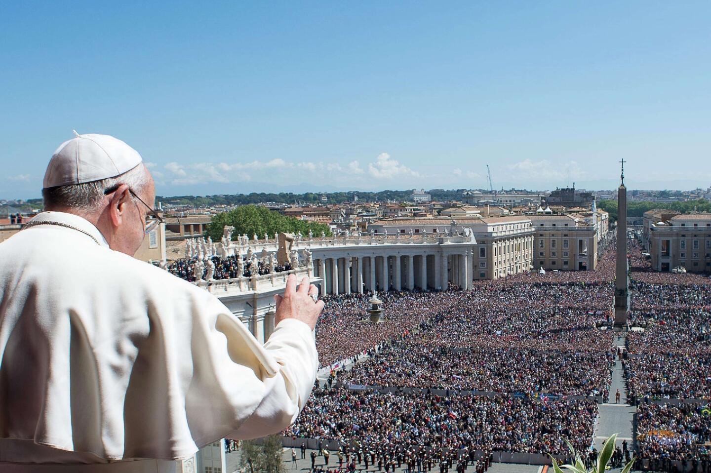 Pope Francis delivers the traditional blessing for Rome and the world from the balcony of St. Peter's Basilica during Easter celebrations.