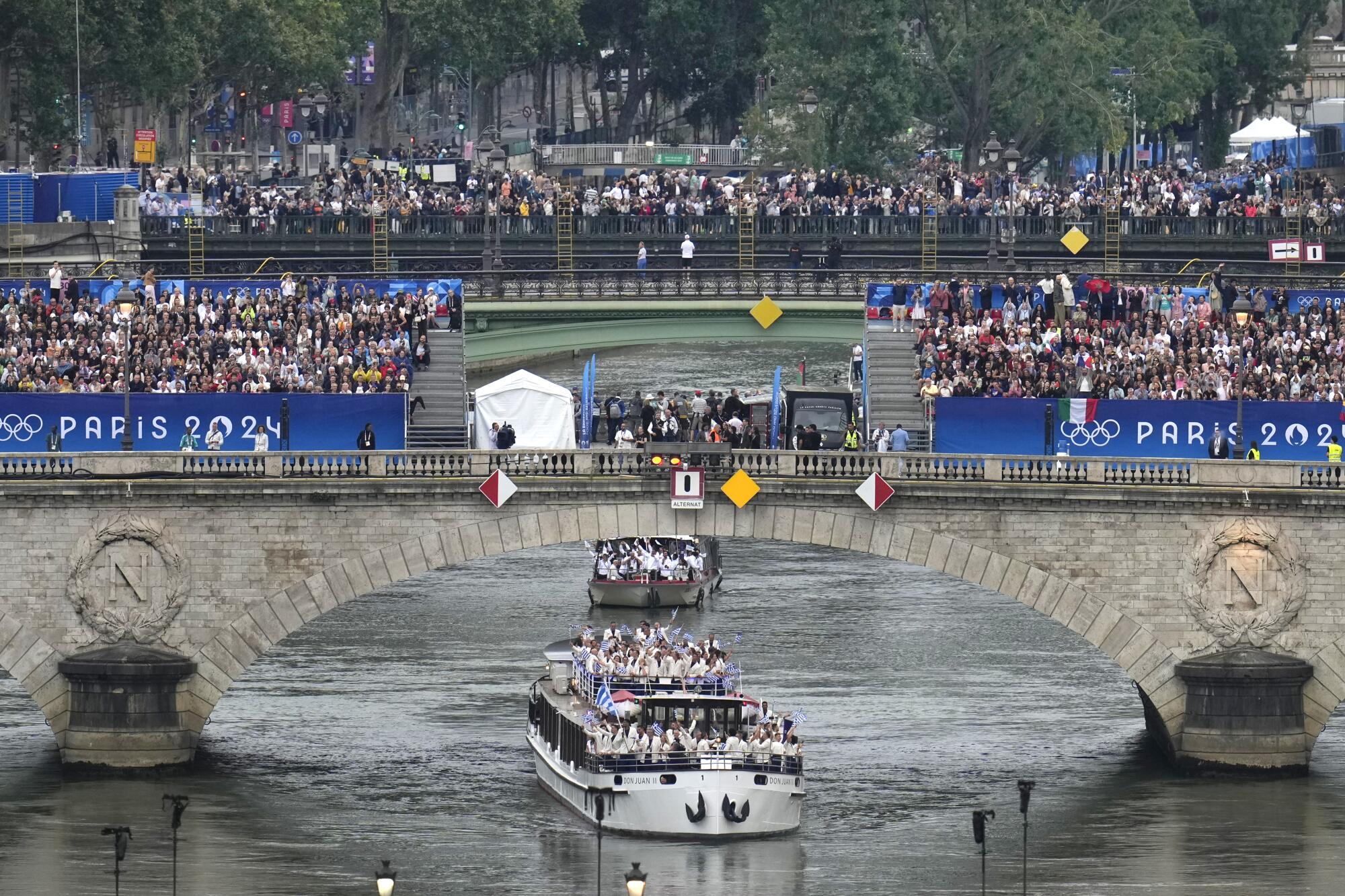 Team Greece travel by boat along the Seine river in Paris, France.