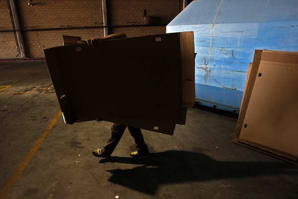 Artist Ramiro Gomez, 25, collects discarded cardboard from a store. Gomez uses the cardboard as a canvas to paint his series on Latino gardeners, nannies and day laborers.