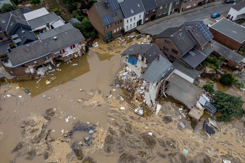 A view of destroyed houses in Erftstadt-Blessem, Germany, Saturday, July 17, 2021. Flooding in west Germany and Belgium has killed over 125 people, with hundreds more missing and thousands now homeless. (AP Photo/Michael Probst)