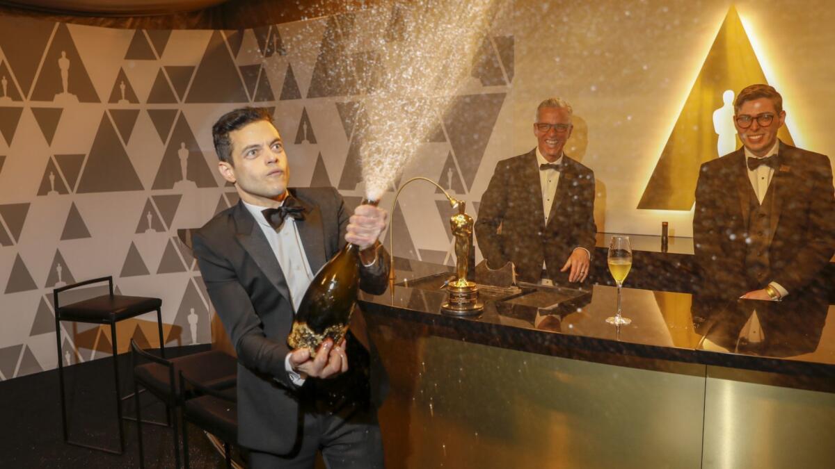 Rami Malek, winner of the lead actor Oscar, pops Champagne at the Governors Ball following the 91st Academy Awards.