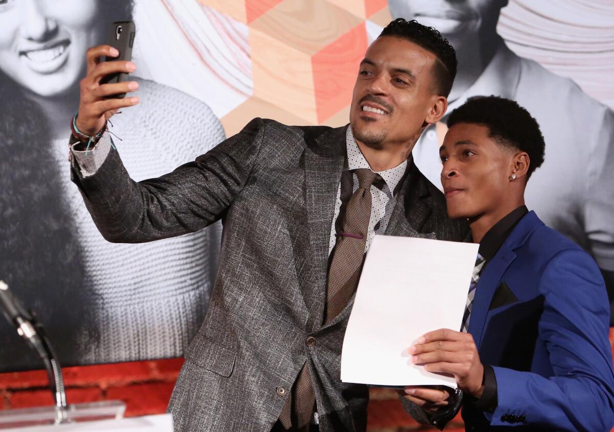 NBA player Matt Barnes, left, and honoree Chase Moore take a selfie onstage at Children's Defense Fund - California's H24th Annual Beat the Odds Awards.