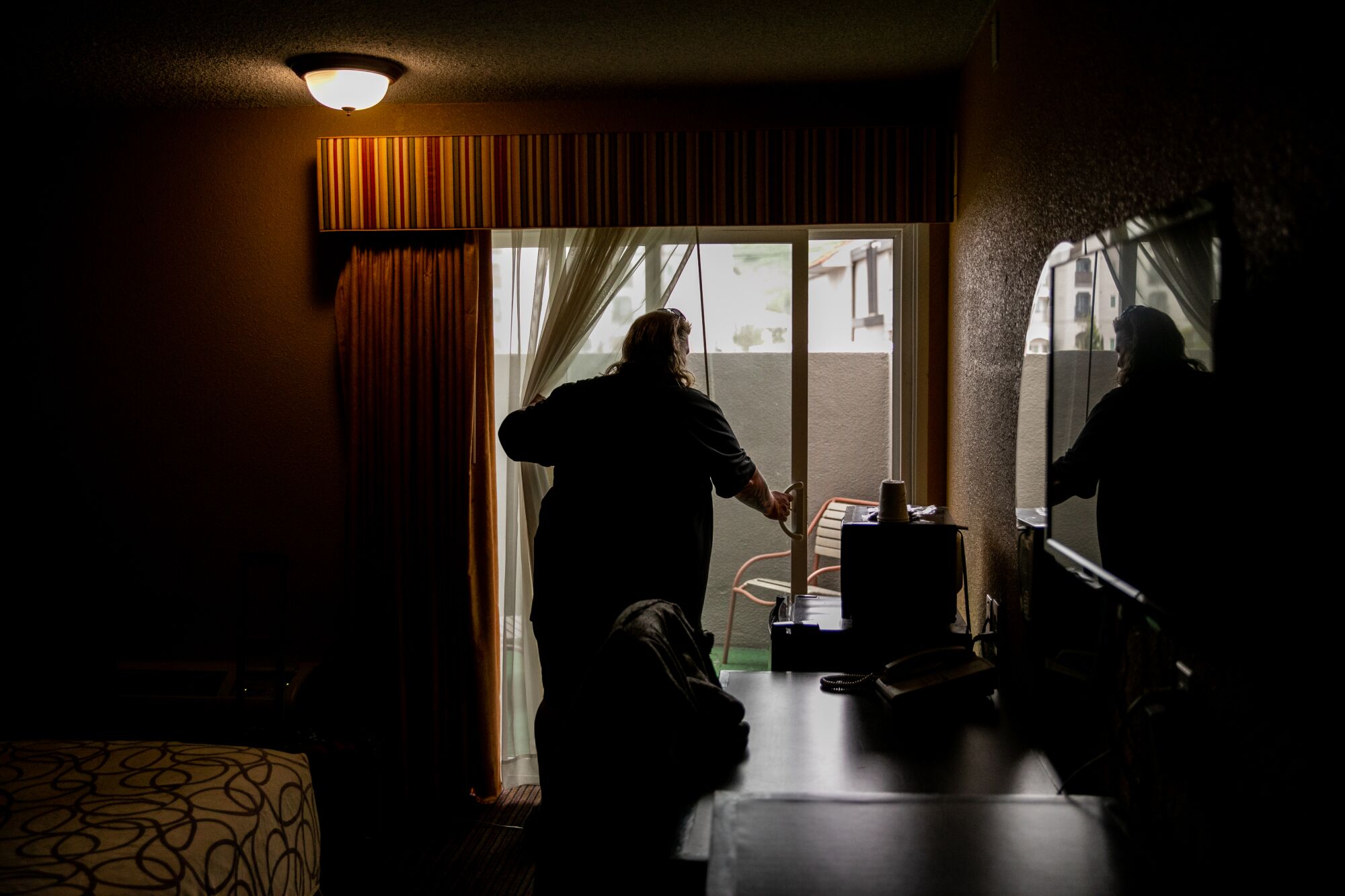 Sean M. Kelley moves into his room at Marty's Valley Inn on Tuesday.