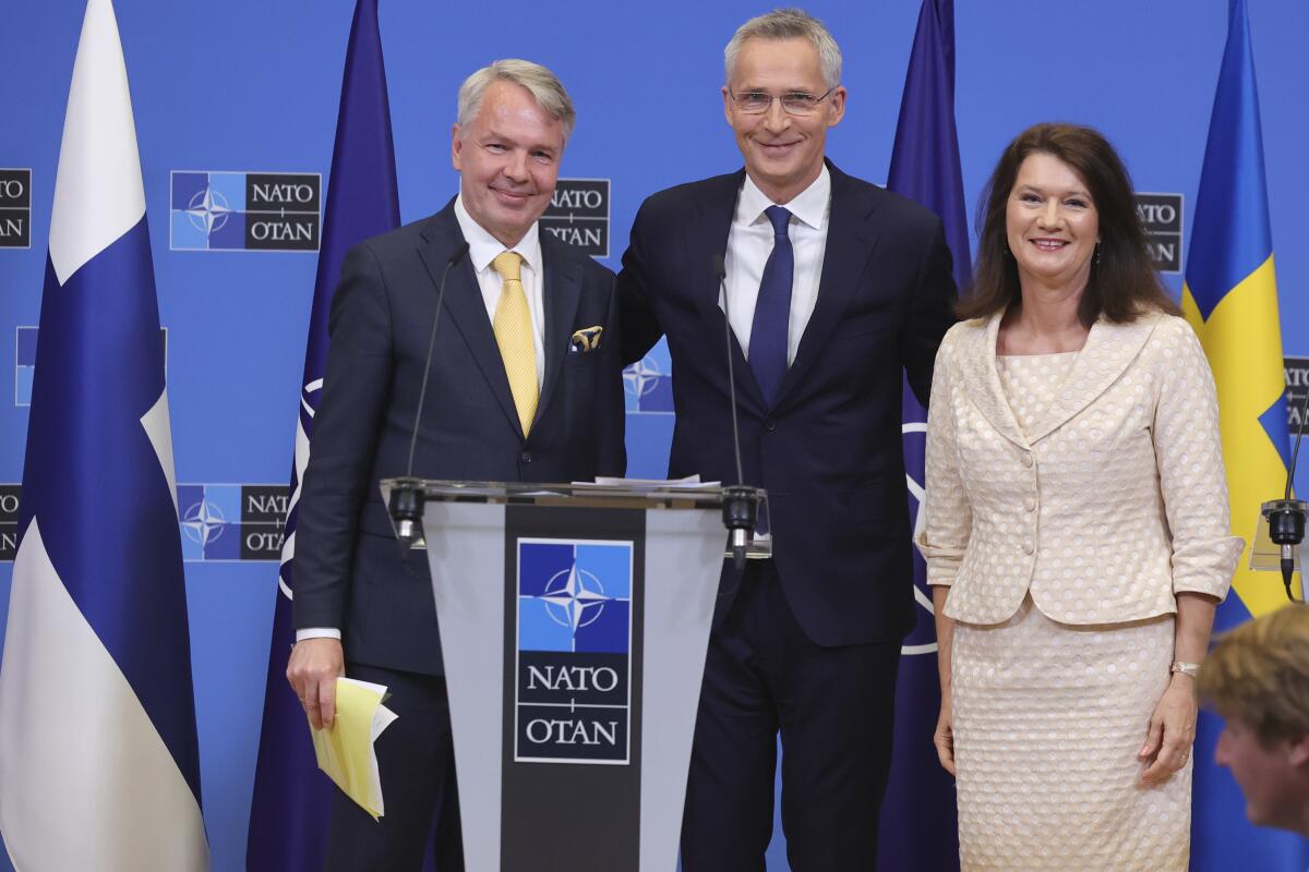Finland's Foreign Minister Pekka Haavisto, left, Sweden's Foreign Minister Ann Linde, right, and NATO Secretary General Jens Stoltenberg attend a media conference after the signature of the NATO Accession Protocols for Finland and Sweden in the NATO headquarters in Brussels, Tuesday, July 5, 2022. (AP Photo/Olivier Matthys)