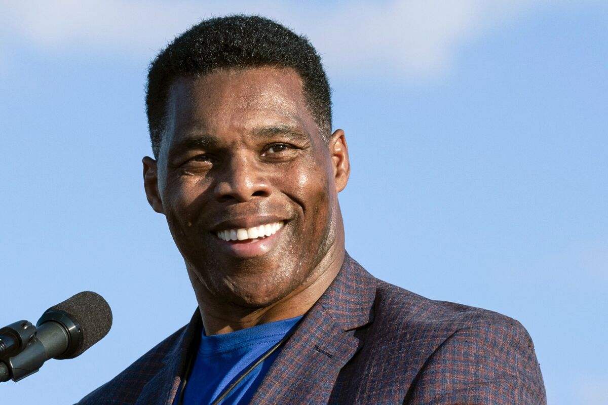 FILE - Georgia Republican Senate candidate Herschel Walker speaks during former President Donald Trump's Save America rally in Perry, Ga., on Sept. 25, 2021. Walker has a message for the Republicans in the tight race for the party’s nomination for governor in Georgia: Don’t count on help from me, for now. A football legend in a sports-crazed state whose Senate campaign is backed by former President Donald Trump, Walker is running far ahead in Georgia's May primary. So far, Walker is refusing to get involved and is increasingly expressing exasperation with the negative tone of the governor's race.(AP Photo/Ben Gray, File)
