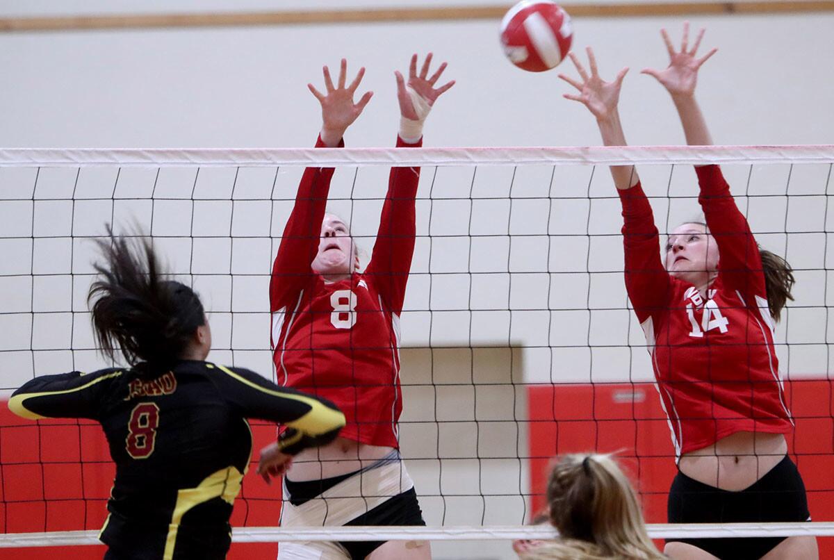 Burroughs High School girls volleyball player #8 Shea McGovern and #14 Maggie Harris go up for the block in game vs. Arcadia High at home in Burbank on Wednesday, Oct. 3, 2018. Burroughs Indians beat the Arcadia Apaches 3-0.