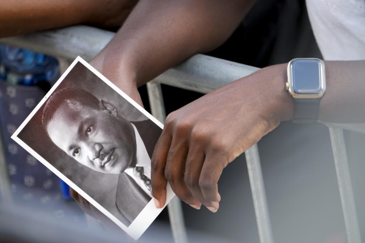 A person holds an image of the Rev. Martin Luther King Jr. 