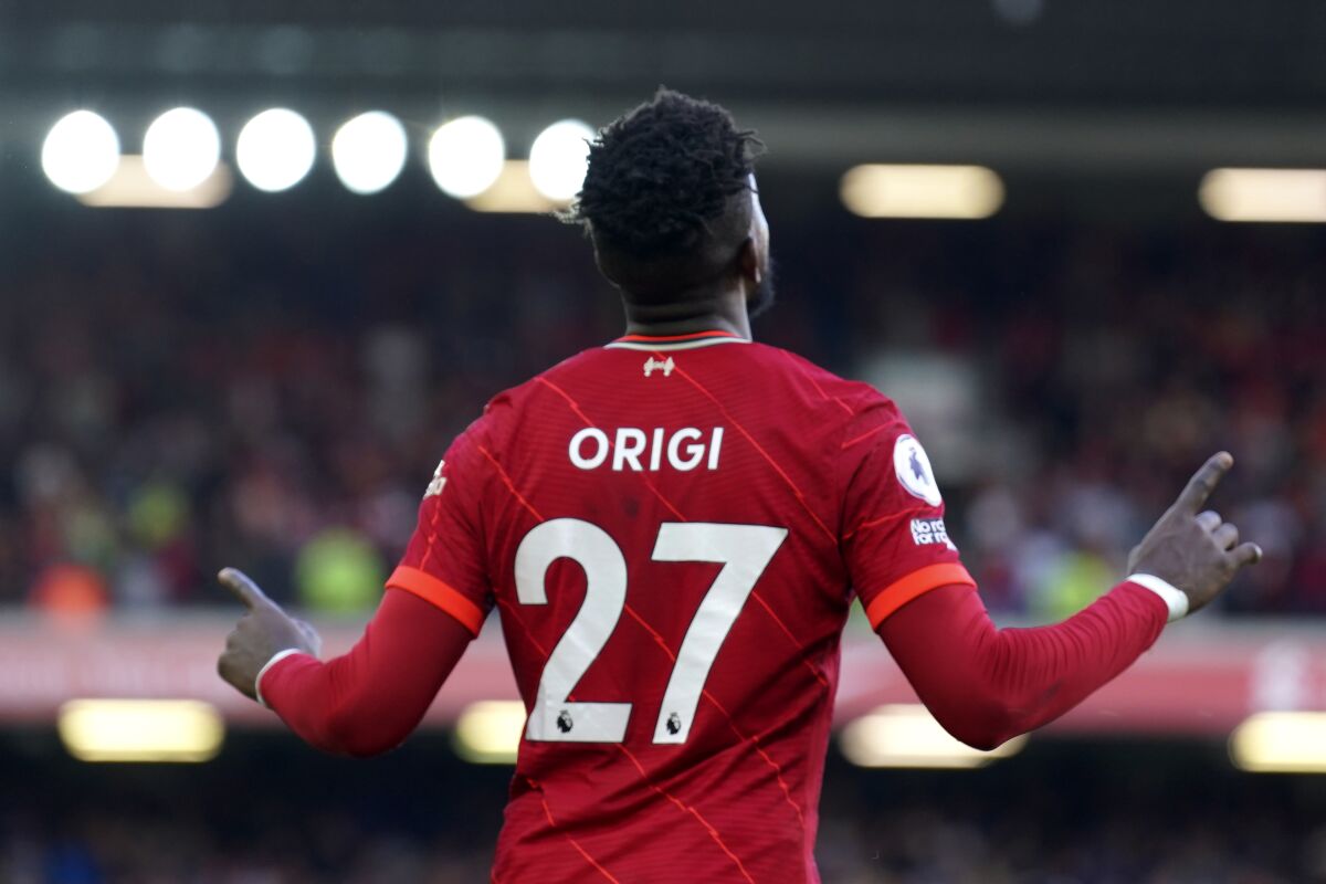 Liverpool's Divock Origi celebrates after scoring his sides second goal during the English Premier League soccer match between Liverpool and Everton at Anfield stadium in Liverpool, England, Sunday, April 24, 2022. (AP Photo/Jon Super)