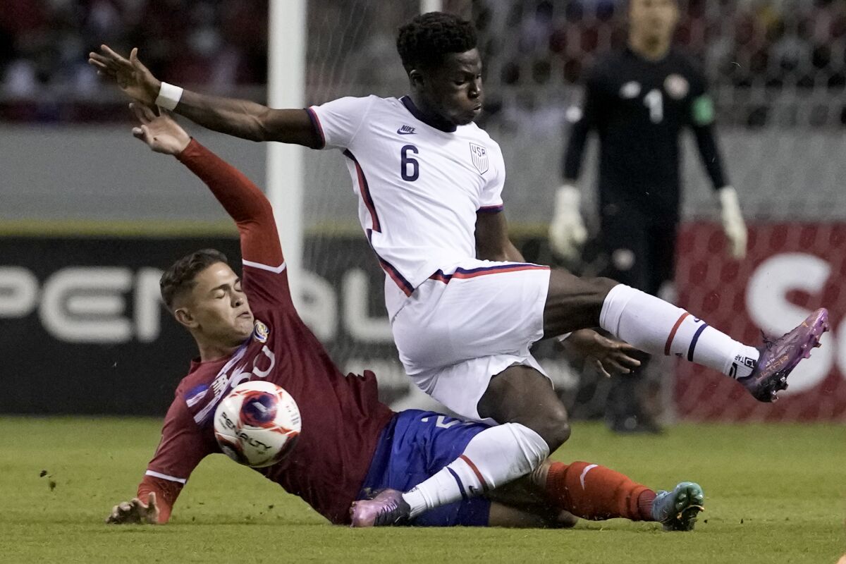 Costa Rica's Brandon Aguilera, below, and the United States' Yunus Musah battle for the ball 