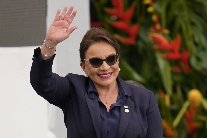 FILE - Honduras' President Xiomara Castro waves during the swearing-in ceremony for Colombia's President Gustavo Petro in Bogota, Colombia, Sunday, Aug. 7, 2022. Castro has flown to China on Tuesday, June 6, 2023, to meet with President Xi Jinping. (AP Photo/Fernando Vergara, File)