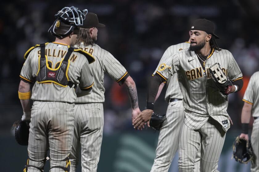 San Diego Padres catcher Brett Sullivan, left, celebrates with pitcher Josh Hader, middle, and right fielder Fernando Tatis Jr. after the Padres defeated the San Francisco Giants in a baseball game in San Francisco, Tuesday, Sept. 26, 2023. (AP Photo/Jeff Chiu)