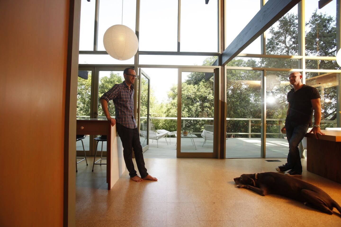 Owner Christophe Burusco, left, and designer Scott Lander in what today would be called a great room, with glass looking onto the rear deck and flooring made of cork.
