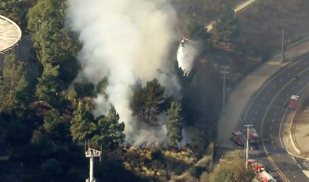 Firefighters battle a blaze in the Sepulveda Pass.
